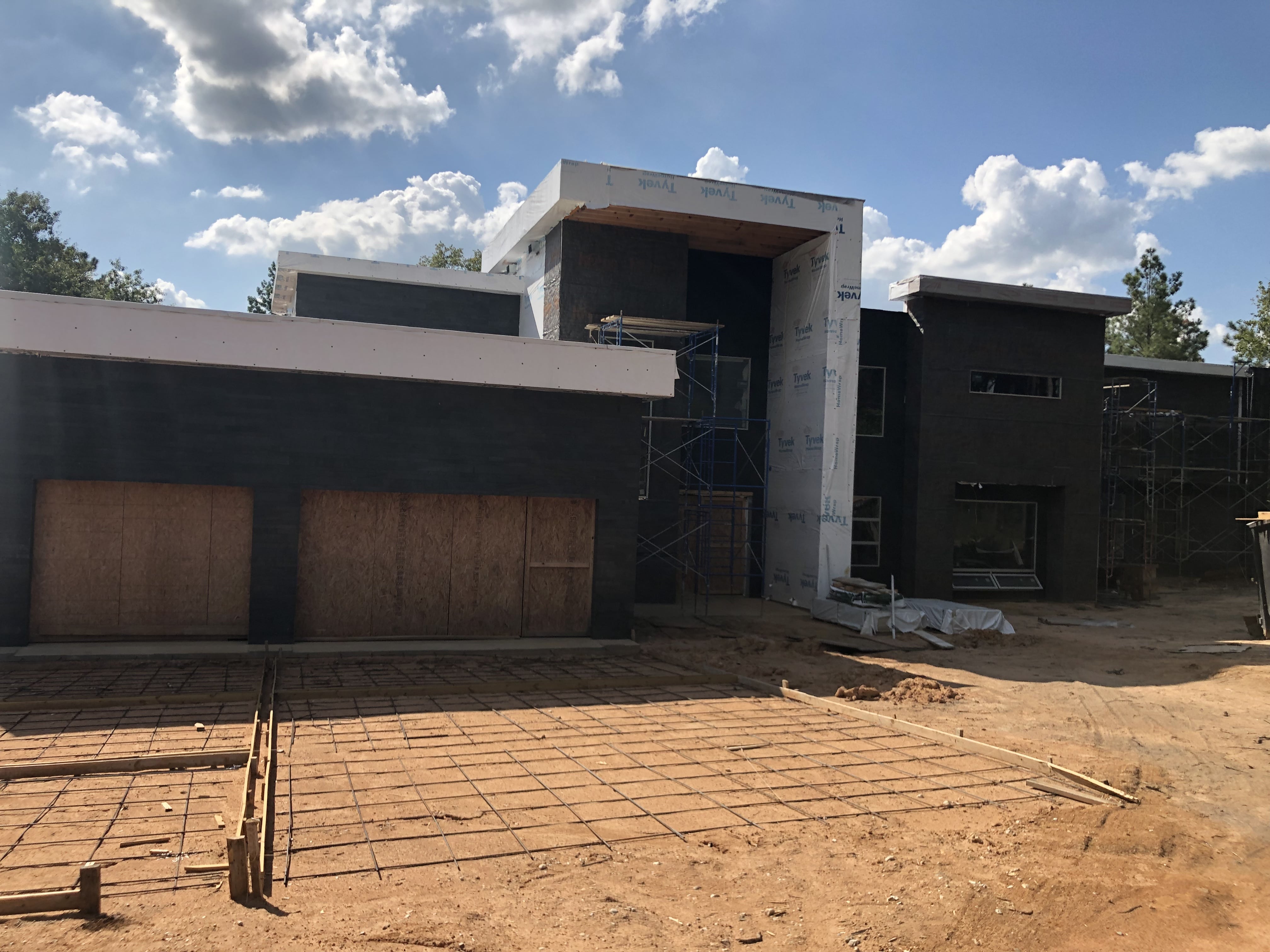 Norstone Graphite Planc Large Format Tile on the facade of a modern home under construction